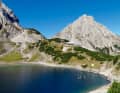 In the morning light, the Sonnenspitze towers over Drachensee lake. The hikers in the Coburger Hütte are still slumbering. The team does not enjoy the magnificent view for long - there are still eight lakes waiting for them.