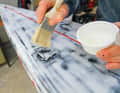 2. first coat of epoxy resin: Mix epoxy resin with hardener in precisely measured quantities in a shallow container. Using a flat brush, spread a thin layer of the compound evenly over the repair area.