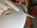 The wooden "stringer" in the centre is worked on with a small file