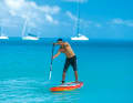 Now use your hips, abdominal muscles, shoulders and arms to guide the paddle to the front of the board and turn it. The aim is to push water under the board with the paddle