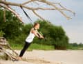 Grip the sling trainer with both hands, straighten your arms and build up body tension