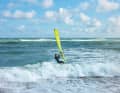 As soon as you are behind the crest of the wave, catch up again and try to stay on the back of the wave directly behind the crest. Surf as far up the beach behind the crest as possible