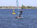 Initiate the following 180-degree turn to windward by luffing. In light winds, slide your back hand on the boom a little further forwards towards the mast - this way you can tilt the sail and still keep your upper body upright.