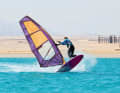 The bent back leg pulls the tail slightly under the body so that the bow touches the water first.