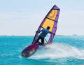 ...and pull the sail towards your body with your front hand to grab the other side of the sail "boom to boom" with a cross grip.
