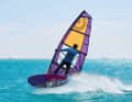 Immediately after the jump, release your back hand from the boom...