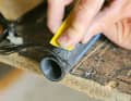 5. remove adhesive residue: Before wrapping the repair area with the roving, Oliver first cleans the tear of any superglue residue using the cutter knife and some sandpaper.