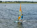 2) Prepare to drop by moving the sail hand on the boom slightly backwards towards the end of the boom and placing the back foot slightly back towards the stern.
