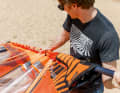Push the mast into the mast pocket from below and pull in "concertina style" until the sail is fully hoisted.