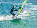 Now let the sail pull you into the turn by stretching the mast arm and holding the sail tight with your back hand