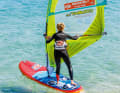 Before you fall off, reach far back towards the end of the boom with your sailing hand on the boom. Because the sail draft will naturally increase when you fall off, it helps to shift the weight a little further back before falling off, especially in stronger winds.