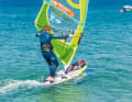 Ride a basic jibe and change the foot position to downwind as usual