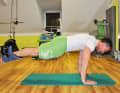 Get into a push-up position and hang your legs on the trapeze