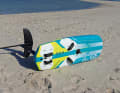 If the board is lying alone on the beach, e.g. if you need to change the sail, it is best to lay your board with the stern into the wind and turn the foil on its side