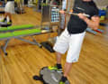Take a pole - this simulates your boom - and then: Let's go indoor surfing. Keep pulling the pole towards your chest ...