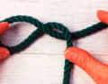 Turn the eye another 180° in the same direction. This creates the typical figure-eight shape.