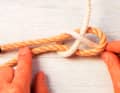 Insert the working end under its own fixed part. Both loose ends must be on the same side of the knot, which is particularly important with different materials and unequal thicknesses.