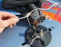 ...and attach the rope to the luff adjuster of your rig. Make sure that the board and rig are fixed as close together as possible, otherwise the foot of the mast will be too far outside the centre of the board