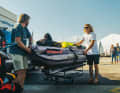 Trolley after trolley, along the narrow dock. Packed full of surfing equipment heading towards the ship.