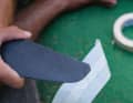 The fin is then taped with crepe on one side as a working base.
