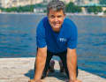 Standing on four feet, place your hands on the floor with your fingers pointing towards your body...