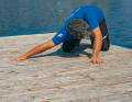 As a variation, you can also place one arm 90 degrees to the side and try to touch the floor with your chest