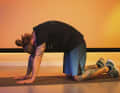 Then exhale and pull your stomach in while bringing your chin to your chest and arching your back upwards