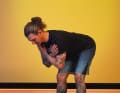 Bend forwards slowly, keeping your back straight and your chest proud