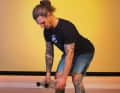Bend forwards by tilting your pelvis back and bending your knees slightly. Keep your back straight and your chest proud. Let your arms dangle loosely downwards.