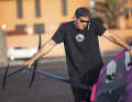 It's hard enough for any normal surfer to tame his foil board on land, while Nico talks business with the sponsor.