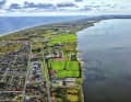 The narrow headland Holmsland Klit separates Ringkøbing Fjord from the North Sea. The picture shows the spot Hvide Sande Nord.