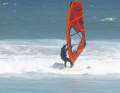 Glide towards the beach with a small foam wave on a light closehauled course - a knee-high wave is absolutely sufficient. Open the sail, unhook from the harness and simply let the wave push you. Take a big step forwards.