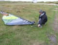 Slide it under the bow of your board and release the luff adjuster