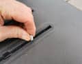 The first step is to screw the stud bolts into the track nuts in the rail