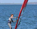 To prevent the board from rising uncontrollably during this phase and the foil from losing contact with the water, try to consciously keep your altitude low. You can do this by consistently pushing the mast away from your body and forwards towards the bow by stretching the mast arm.