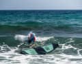 Even when crossing waves, the body always remains on the top of the board, with a firm grip on the straps