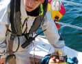 Rely on expert help near the harbour. Patient in a rescue blanket and ashore