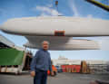 The hull of Jourdain's Outremer 5X hangs in the crane.