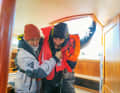 Escort below deck: If the crew member was only in the water for a short time, is clearly responsive and can still move, then go below deck with assistance