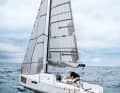 Furling early. Now it's a matter of two things: completing the tack and at the same time tightening the genoa before it catches full wind. It is better to manoeuvre slowly and cleanly than to drop too far or stop in the wind