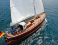 Double-ender: From the saling perspective, the pointed gate looks narrow.  Contemporary: carbon mast, rig hydraulics, push rod steering. And the moulded wood construction instead of planks