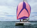 An asymmetric gennaker with a large head angle, sheeting to windward, is also well suited for larger wind angles of incidence