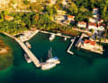 There is room for a handful of boats in the small harbour of Ljuta. On the left, the old mills and restaurant in the greenery