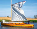 The mighty gaff mainsail is wrapped around the main boom for hoisting and reefing, the small jib is travelled on staysails