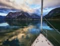 Mountains off the bow: inland, the granite grows into high walls, the wind is not reliably predictable