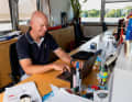 The club manager and sports director at his workplace in the clubhouse of the NRV, which was founded in 1868. The address is Schöne Aussicht 37: Schöne Aussicht 37 - the name says it all: Klaus Lahme looks out over the jetties directly onto the picturesque and challenging waters of Hamburg's Outer Alster lake