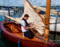 Jannik Lukat rigging his naturally varnished "Mósi". The master boat builder from Glückstadt built the Grat Southby catboat himself