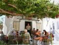 In Parikia there is a café with seating under the branches of a tree