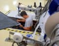 Master sailmaker Lennard Peilicke completing a black genoa