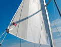 The grey part aft protects the permanently rolled out clew from UV radiation